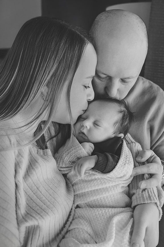 Newborn baby peacefully sleeping during in-home photography session